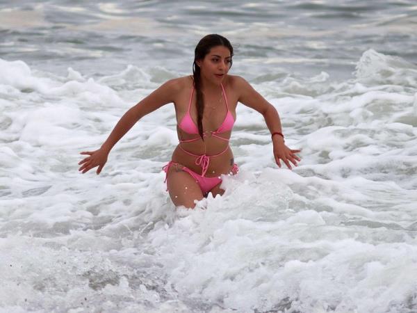 A tourist plays in the surf in Puerto Vallarta, Mexico, on October 9, 2023, hours before Tropical Storm "Lidia" is expected to reach the coast.